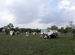 Paintball players near tanker truck on the Normandy course at Splatterhouse Paintball Field.